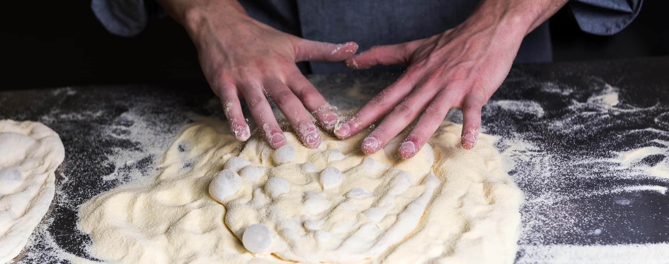 Detail of a cook's hands kneading.