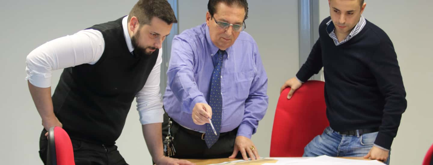 Photo of Corrado di Marco and two members of staff in an office