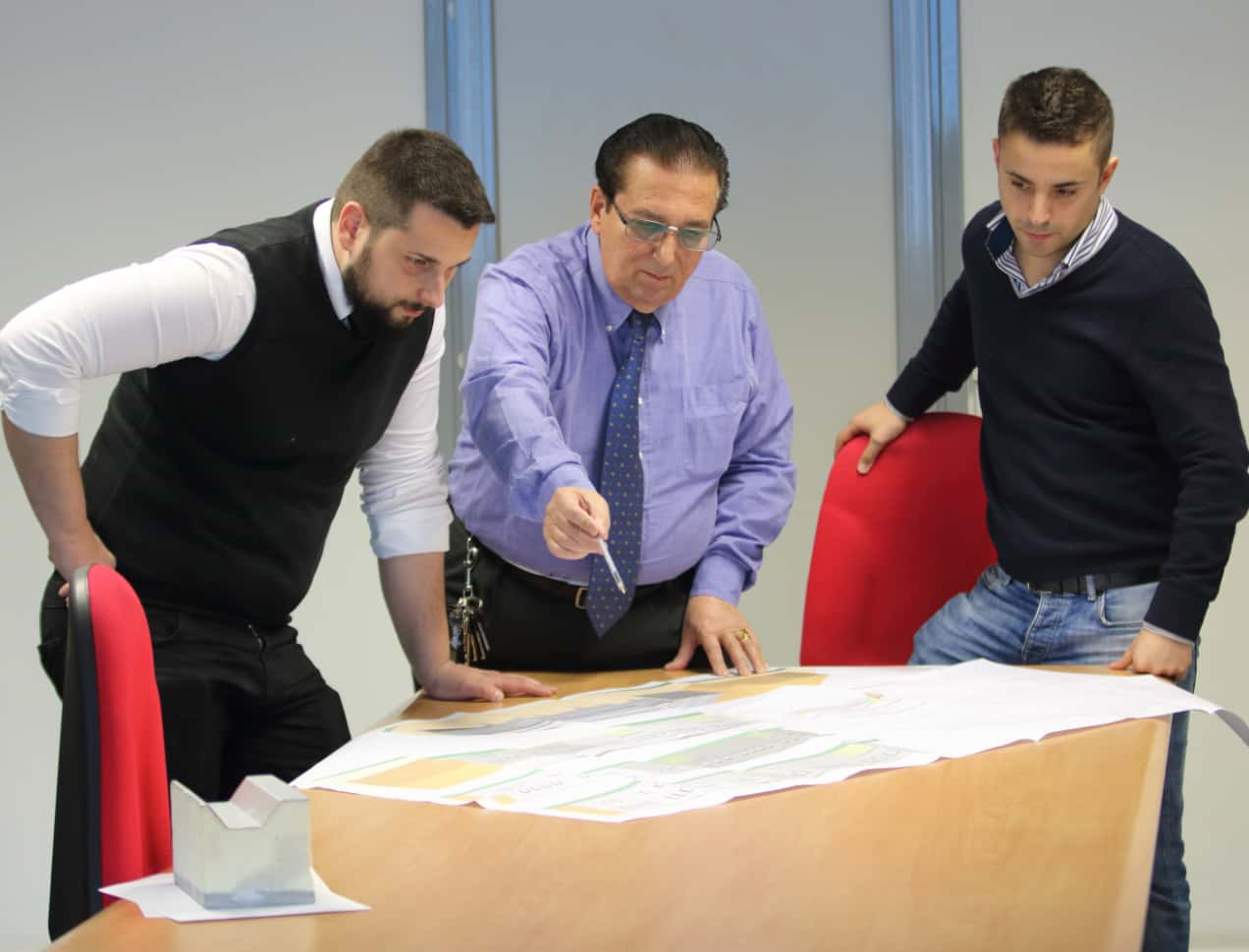 Photo of Corrado di Marco and two members of staff in an office