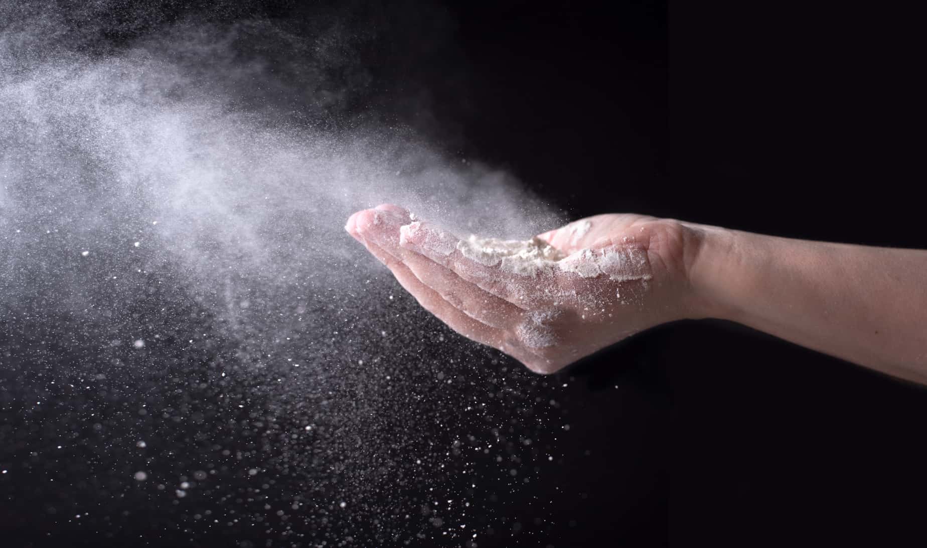 Detail of a hand with flour